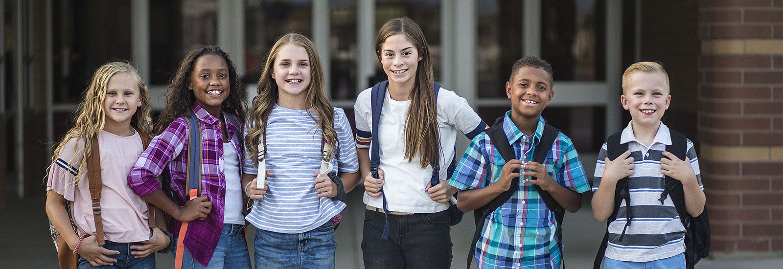 NDE Hero - 6 students with backpacks on smiling